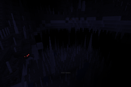 Dark(!) image of an underground caves with lots of dripstone