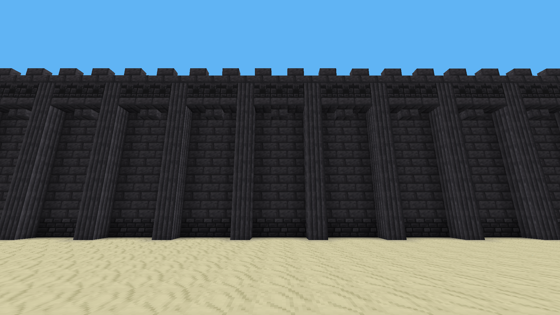 A wall made of deepslate bricks, deepslate pillars, deepslate tiles, and chiselled deepslate