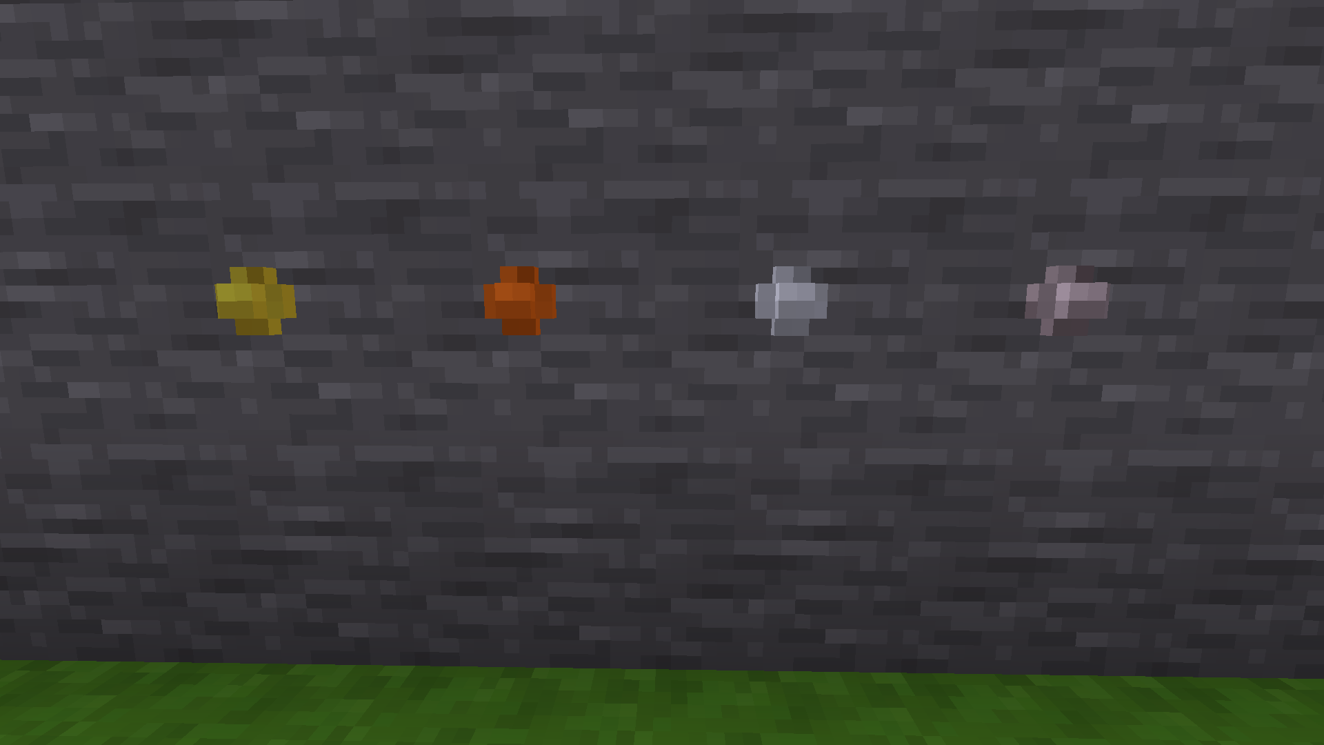 A stone wall in Minetest Game with a rivet each of brass, bronze, steel, and titanium